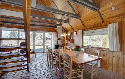 a dining room with a wooden table and chairs at 4 Bedroom Pet Friendly Home In Løgstør in Løgstør