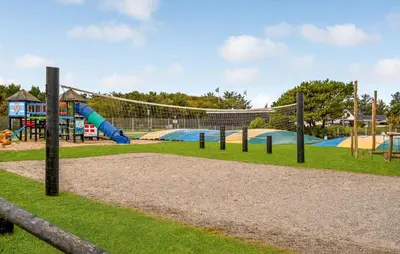 a playground with a slide and swings at 1 Bedroom Nice Home In Vestervig in Vestervig