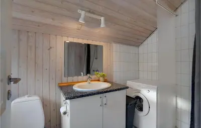 a bathroom with a sink and a washing machine at Lovely Home In Vestervig With Wifi in Vestervig