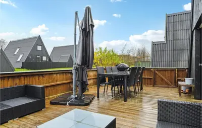 a patio with an umbrella and a table and chairs at Amazing Home In Farsø With Wifi in Farsø