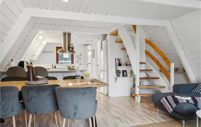 a dining room with a table and blue chairs at Amazing Home In Farsø With Wifi in Farsø