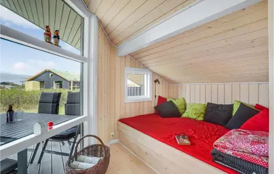 a small room with a bed and a table at 3 Bedroom Lovely Home In Vestervig in Vestervig