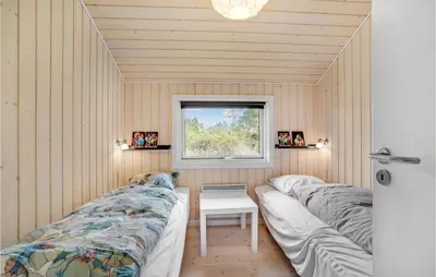 two beds in a room with a window at 3 Bedroom Lovely Home In Vestervig in Vestervig
