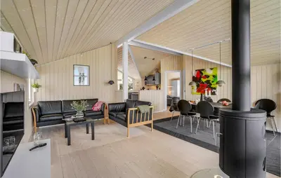a living room with a couch and a dining room at 3 Bedroom Lovely Home In Vestervig in Vestervig