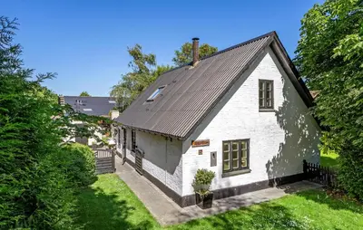 a white house with a black roof at 2 Bedroom Stunning Home In Bedsted Thy in Bedsted Thy