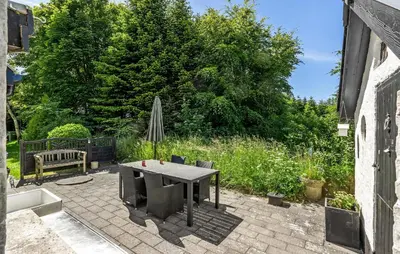 a patio with a table and chairs and an umbrella at 2 Bedroom Stunning Home In Bedsted Thy in Bedsted Thy