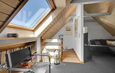 an attic room with a staircase and a window at 2 Bedroom Stunning Home In Bedsted Thy in Bedsted Thy