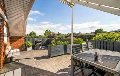 a patio with a table and chairs and a fence at Stunning Home In Roslev With Kitchen in Roslev