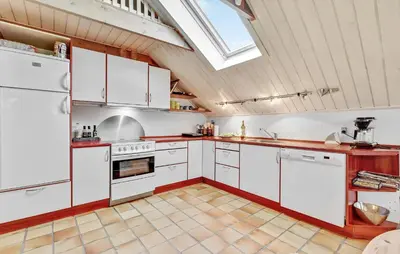 a kitchen with white appliances and a skylight at Stunning Home In Roslev With Kitchen in Roslev