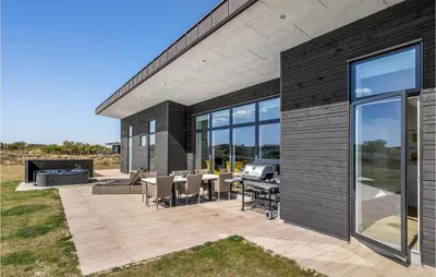 a patio with a grill and tables and chairs at Lovely Home In Thisted With Wifi in Thisted