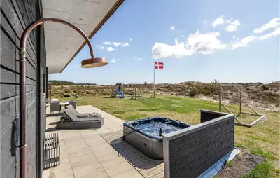 a patio with a hot tub on the side of a house at Lovely Home In Thisted With Wifi in Thisted