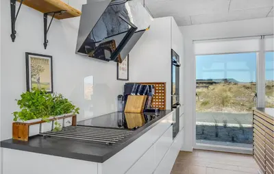 a kitchen with a glass counter and a window at Lovely Home In Thisted With Wifi in Thisted