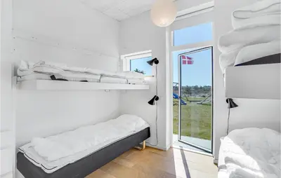 a bedroom with two bunk beds and a window at Lovely Home In Thisted With Wifi in Thisted