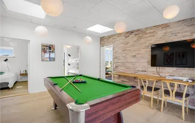 a living room with a pool table and a tv at Lovely Home In Thisted With Wifi in Thisted