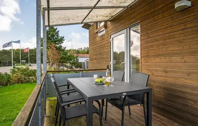 a table and chairs on the balcony of a house at Gorgeous Home In Vestervig With Kitchen in Vestervig