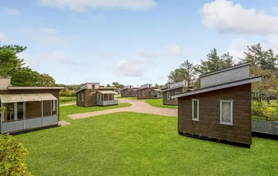 a row of houses in a yard with grass at Lovely Home In Vestervig With Kitchen in Vestervig