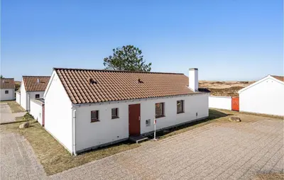 a white building with a red roof on a street at Beautiful Home In Pandrup With Wifi in Pandrup