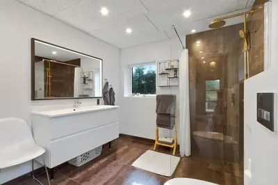 a bathroom with a sink and a shower at Beautiful Home In Blokhus With 1 Bedrooms in Blokhus