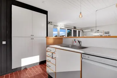 a kitchen with white cabinets and a sink at Beautiful Home In Pandrup With 2 Bedrooms And Wifi in Pandrup