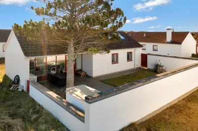 an external view of a white house with a tree at Beautiful Home In Pandrup With 2 Bedrooms And Wifi in Pandrup