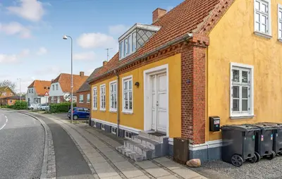 a yellow house on the side of a street at Stunning Home In Vestervig With Wifi in Vestervig