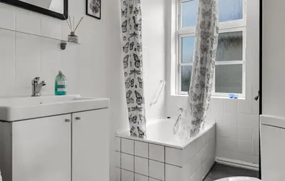 a bathroom with a tub and a sink and a window at Stunning Home In Vestervig With Wifi in Vestervig