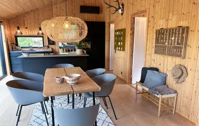 a dining room with a table and some chairs at 3 Bedroom Cozy Home In Blokhus in Blokhus