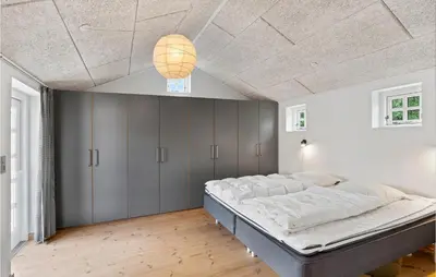 a bedroom with a large bed and a ceiling at Beach Front Home In Lemvig With Wifi in Lemvig