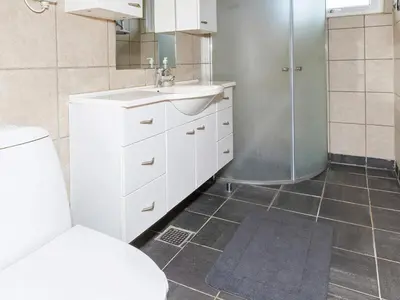 a bathroom with a white sink and a shower at 6 person holiday home in Thisted-By Traum in Torsted