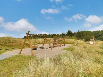 a playground in the middle of a field at Holiday Home Alita - 1-2km from the sea by Interhome in Blokhus