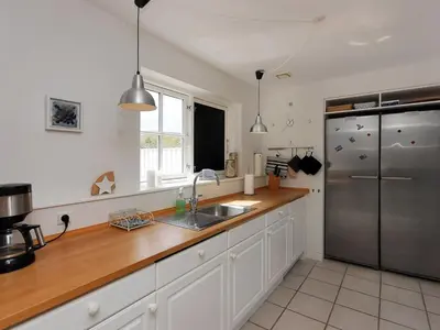 a kitchen with a sink and a stainless steel refrigerator at Holiday Home Alita - 1-2km from the sea by Interhome in Blokhus