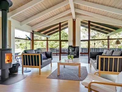 a living room with couches and a fireplace at Holiday Home Kali - 900m to the fjord by Interhome in Løgstør
