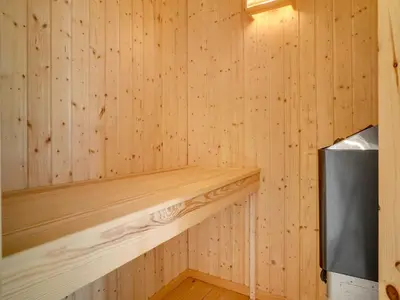 a wooden sauna with a wood paneled wall at Holiday Home Kali - 900m to the fjord by Interhome in Løgstør