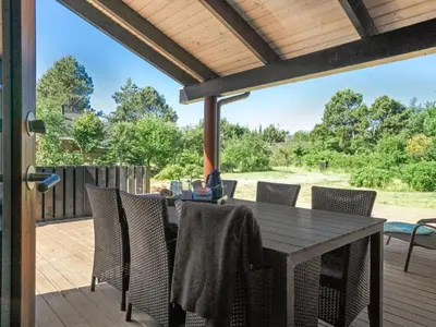 a patio with a table and chairs on a deck at Holiday Home Kali - 900m to the fjord by Interhome in Løgstør