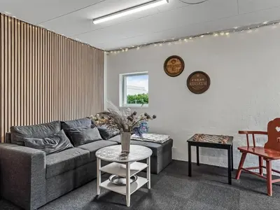 a living room with a couch and a table at Holiday Home Kiersten - 5km from the sea by Interhome in Saltum