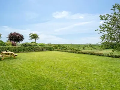 a picnic table in a field of grass at Holiday Home Kiersten - 5km from the sea by Interhome in Saltum