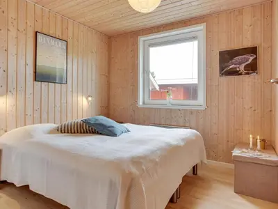a bedroom with a bed in a room with a window at Holiday Home Lisemarie - 800m from the sea by Interhome in Torsted