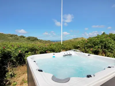 a bath tub in a field of flowers at Holiday Home Ejvind - 100m from the sea by Interhome in Saltum