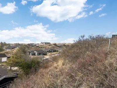 a house on a hill with houses on it at Holiday Home Sharanya - 500m from the sea by Interhome in Blokhus