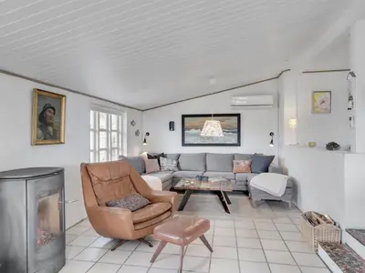 a living room with a couch and a table at Holiday Home Sharanya - 500m from the sea by Interhome in Blokhus