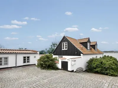 a house with a black and white exterior at Holiday Home Pauliina - 10m to the fjord by Interhome in Roslev