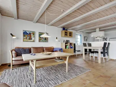 a living room with a couch and a table at Holiday Home Pauliina - 10m to the fjord by Interhome in Roslev