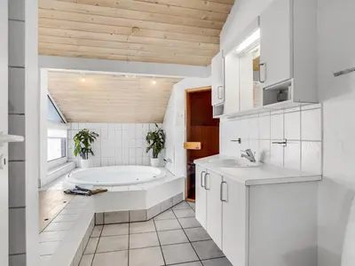 a bathroom with a tub and a sink at Holiday Home Ritha - 350m from the sea by Interhome in Saltum