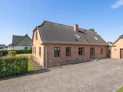a brick house with a driveway in front of it at Holiday Home Iarund - 500m to the fjord by Interhome in Løgstør
