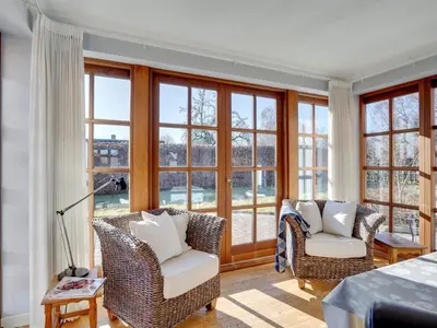 a living room with two chairs and windows at Holiday Home Iarund - 500m to the fjord by Interhome in Løgstør