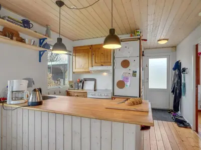 a kitchen with a wooden counter top and a refrigerator at Holiday Home Awer - 300m to the fjord by Interhome in Struer