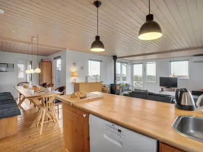 a kitchen and living room with a counter and a table at Holiday Home Awer - 300m to the fjord by Interhome in Struer