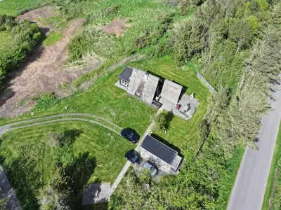 an aerial view of a house and a car on a field at Holiday Home Aranja - 300m to the fjord by Interhome in Løgstør