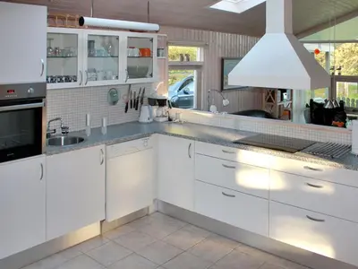 a kitchen with white cabinets and a sink at Holiday Home Annick - 300m from the sea by Interhome in Fjerritslev