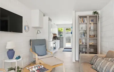 a living room with a couch and a chair at Awesome Apartment In Blokhus With Wifi in Blokhus